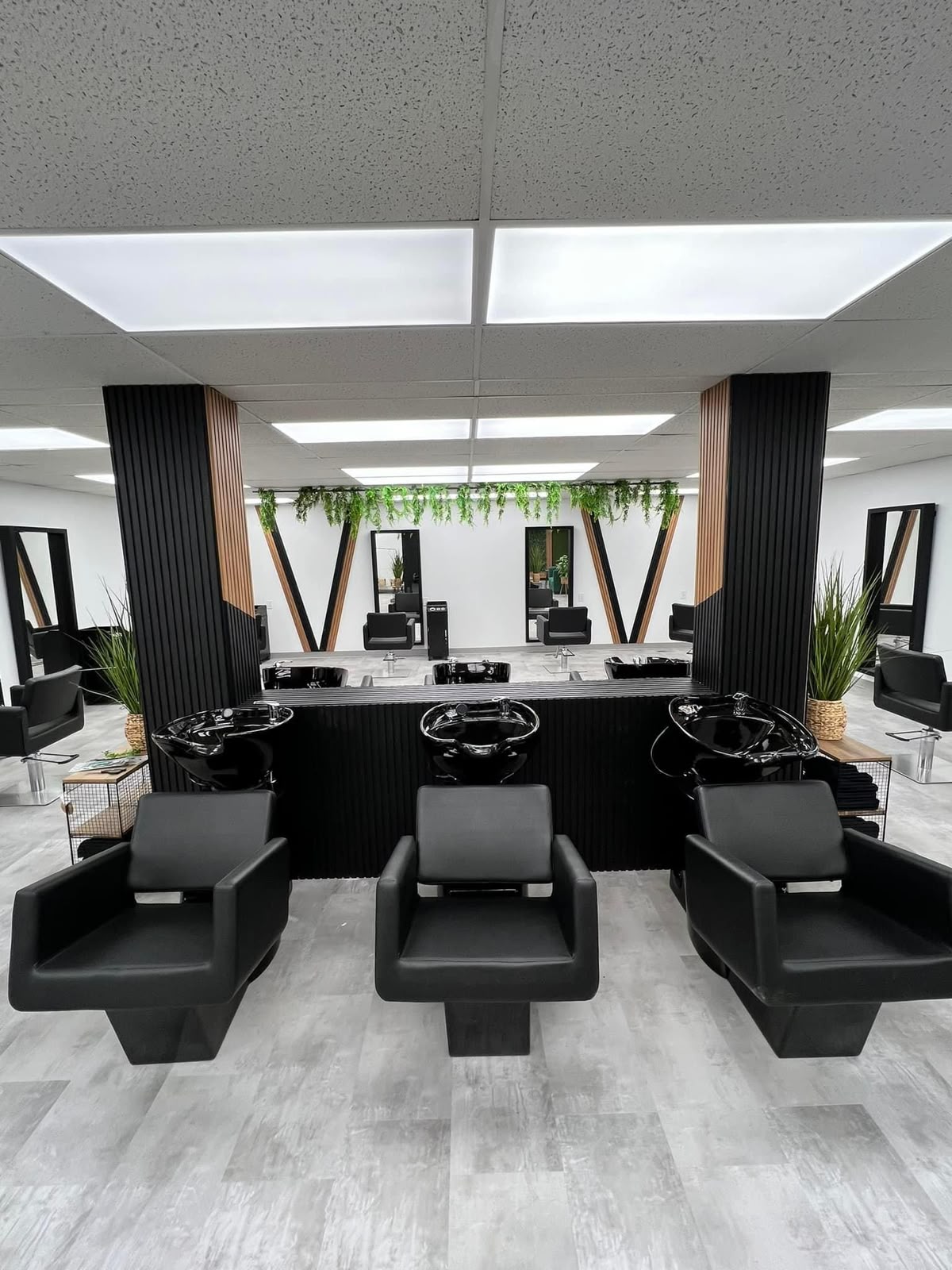 The salon interior with black styling chairs and modern mirrors
